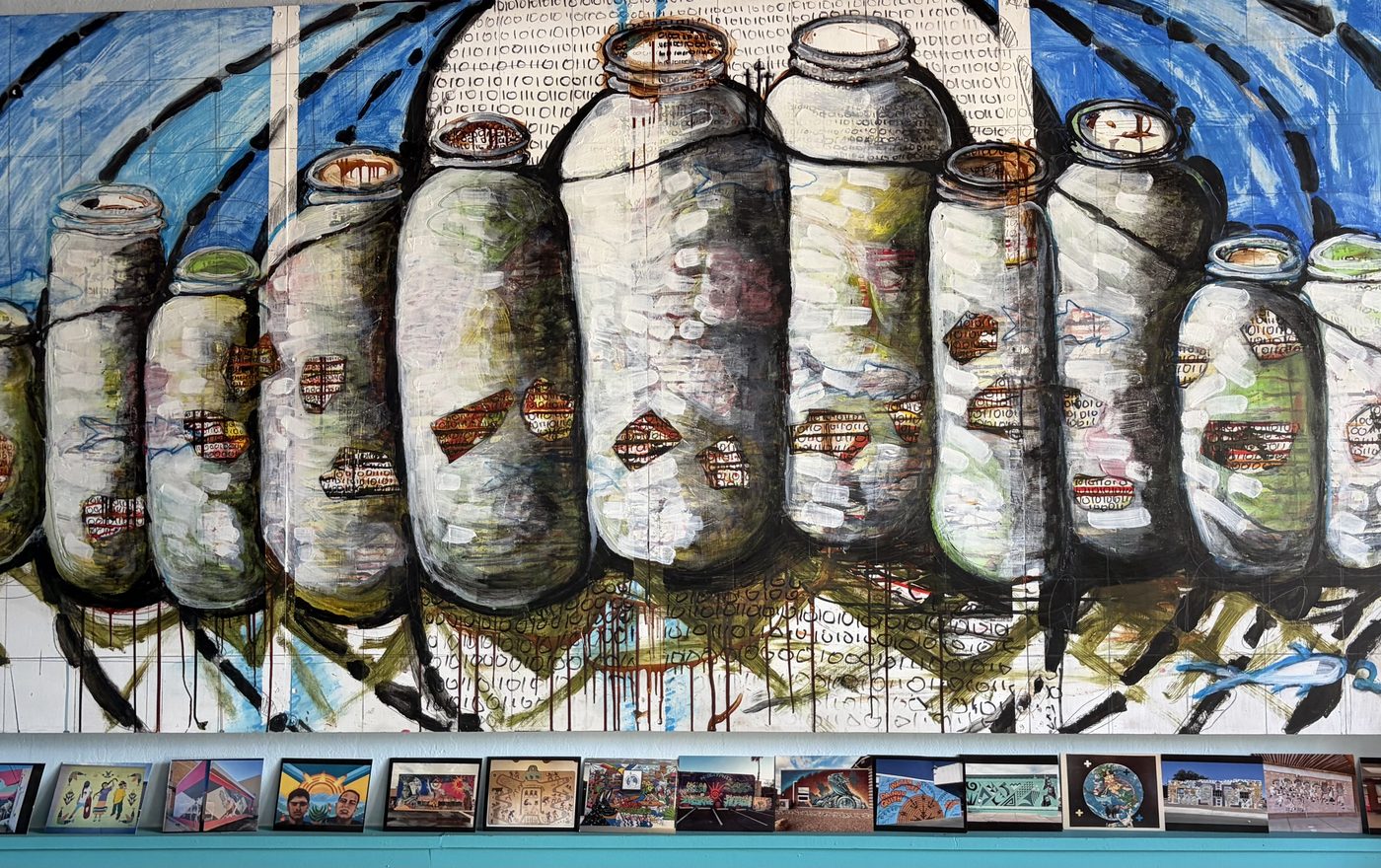 A painted mural of a row of preserving jars, rendered over a background of blue and white binary digits.