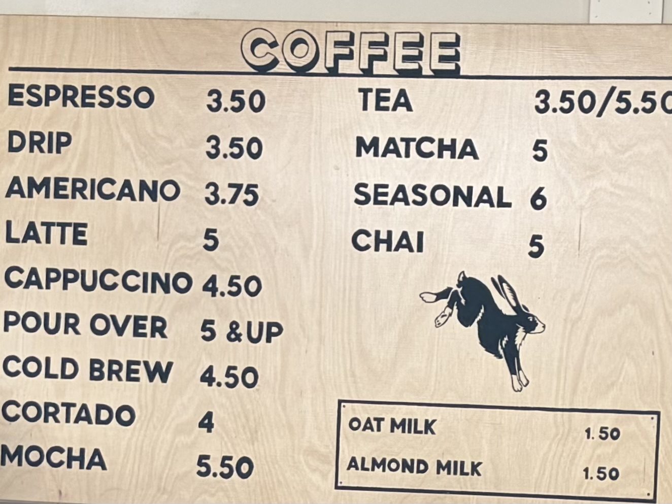 Lasso's plywood coffee board with prices and a jackalope illustration.